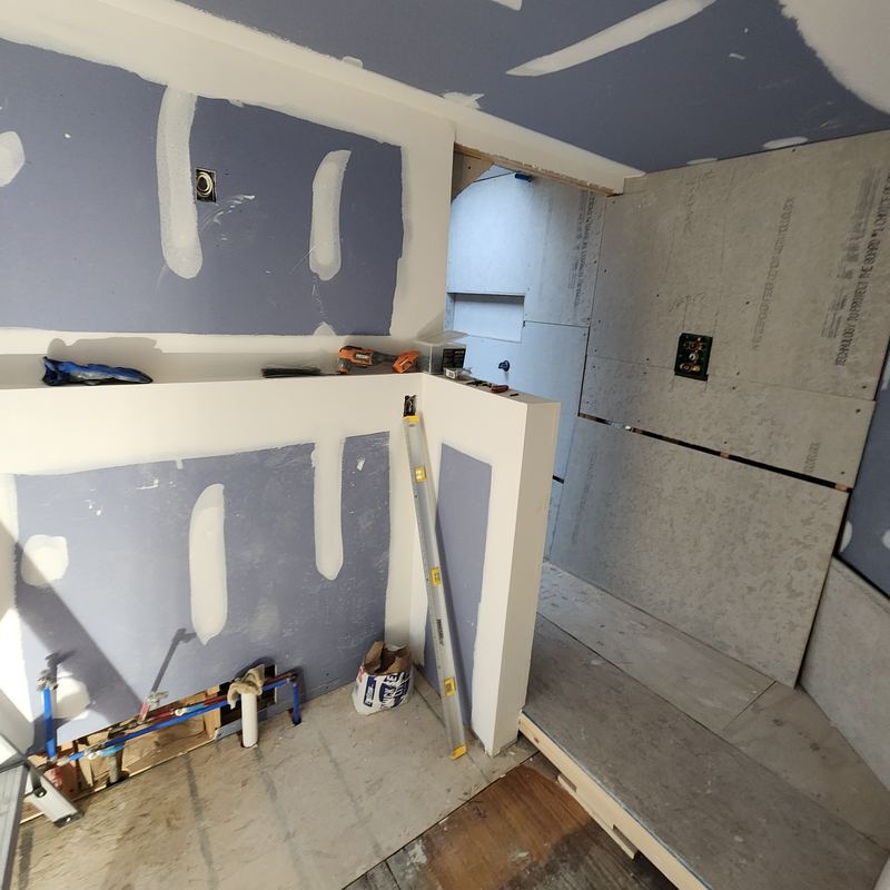Cement board and taped drywall going up